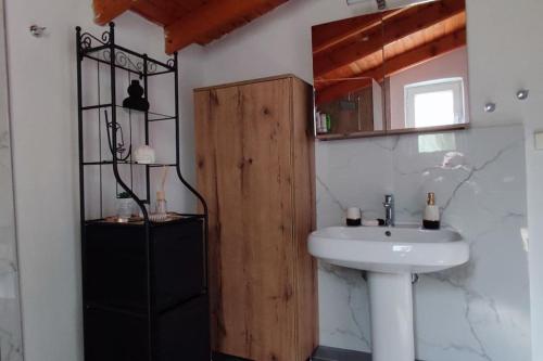 a bathroom with a white sink and a mirror at garden house nafplio in Nafplio