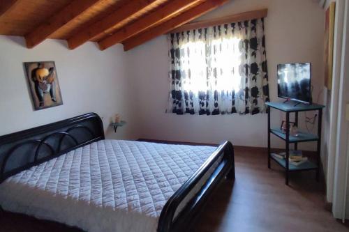 a bedroom with a large bed and a window at garden house nafplio in Nafplio