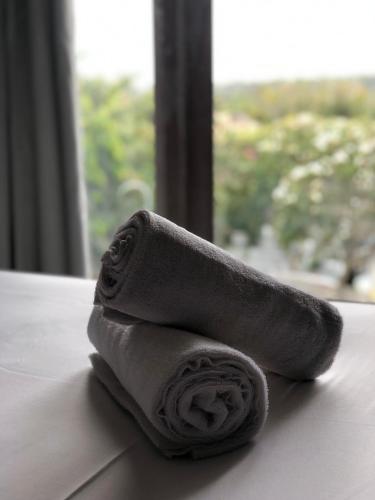 a roll of toilet paper sitting on a table with a window at Bingin Inn in Uluwatu