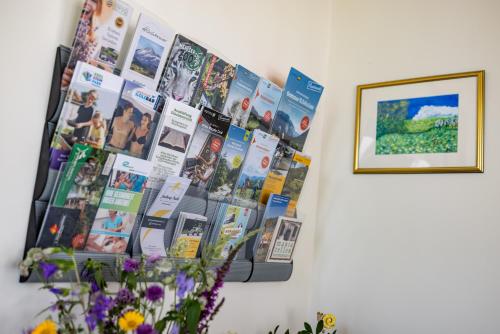 a wall with a bunch of pictures on it at Pension Klug Adults only - DorfResort Mitterbach in Mitterbach