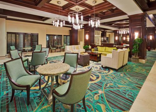 a lobby with chairs and tables and a living room at Holiday Inn Chantilly-Dulles Expo Airport, an IHG Hotel in Chantilly