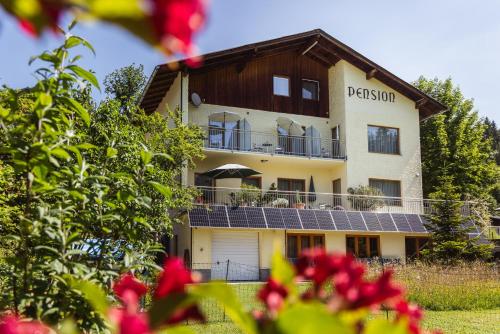 a building with solar panels on the side of it at Pension Klug Adults only - DorfResort Mitterbach in Mitterbach