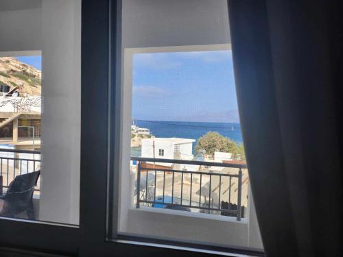 a view of the ocean from a window at ANDRIANOS DELUXE STUDIO in Matala