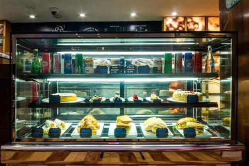 a display case filled with different types of desserts at Camino Real Polanco Mexico in Mexico City