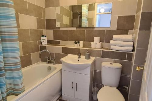 ein Badezimmer mit einem Waschbecken, einem WC und einer Badewanne in der Unterkunft Private 2 Bed Flat close to EXCEL & CITY AIRPORT in London