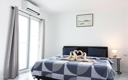 a bedroom with a blue and white bed with a window at Room in Guest room - Baan Khunphiphit Homestay no3370 in Phra Nakhon Si Ayutthaya