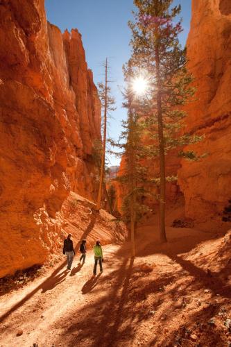 three people walking down a dirt road in a canyon at Park Inn by Radisson, Salt Lake City-Midvale in Midvale