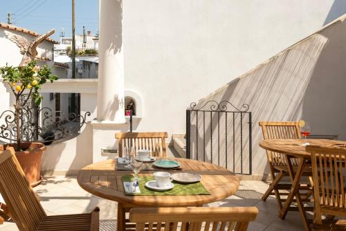 a patio with a table and chairs on a balcony at alle Stelle b&b in Anacapri