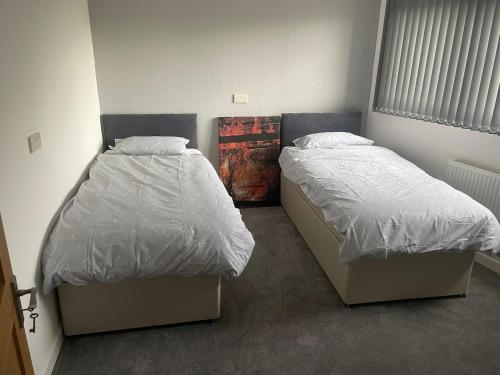 two beds in a small room with at May Disc - Long Stay - Contractors in Bristol