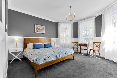 a bedroom with a bed and a table and chairs at Twenty 2 Abbey in Leura
