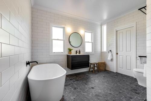 a white bathroom with a toilet and a sink at Twenty 2 Abbey in Leura