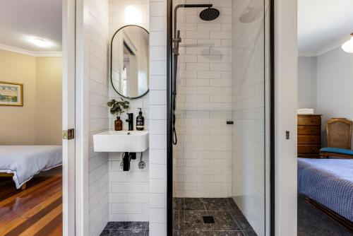 a bathroom with a shower and a sink at Twenty 2 Abbey in Leura