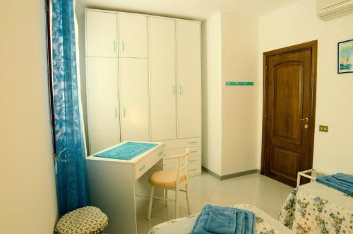 a bedroom with a desk and a bed and a cabinet at Il Melograno in Arzachena