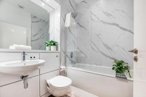 a white bathroom with a sink and a toilet at Host & Stay - Ropewalks Quarters in Liverpool