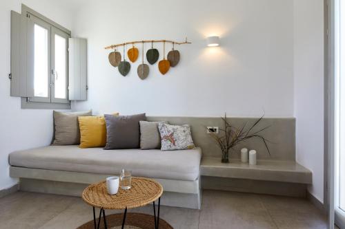 a living room with a couch and a table at Adorno Oia in Oia