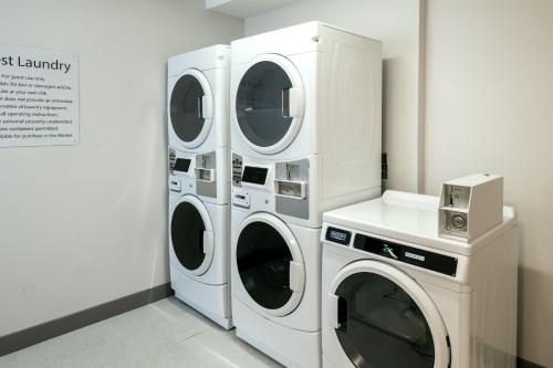 two washing machines and a washer and dryer in a room at Holiday Inn Express Corvallis-On the River by IHG in Corvallis