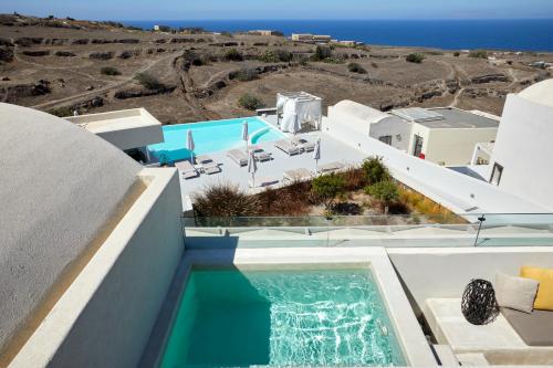 a view of a swimming pool from a house at Adorno Oia in Oia