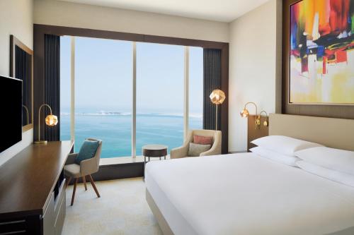 a hotel room with a bed and a large window at Delta Hotels by Marriott City Center Doha in Doha