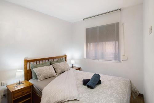 a bedroom with a large bed with a window at San Fernando Apartment in San Bartolomé de Tirajana