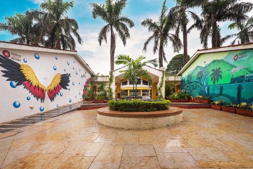a building with a mural on the side of it at Manas Lifestyle Resort, Igatpuri in Igatpuri