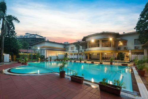 a large swimming pool in front of a building at Manas Lifestyle Resort, Igatpuri in Igatpuri