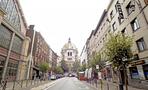 an empty city street with a building in the distance at Albert Hotel in Brussels