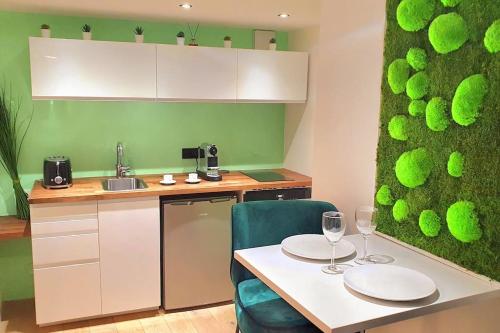 a kitchen with a table with two plates on it at suite st lo 2 in Rouen