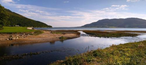 a body of water with mountains in the background at The Nook in Rostrevor
