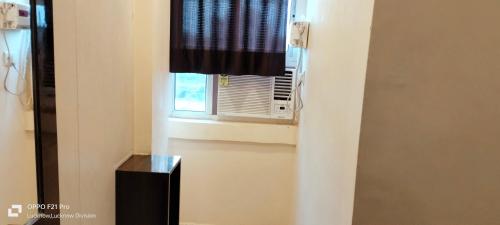 a window with a black curtain in a room at HOTEL KBS in Lucknow