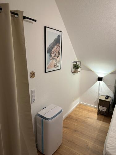 a white room with a stairway with a trash can at Ferienwohnung Dortmund - Elias - Adults Only in Dortmund