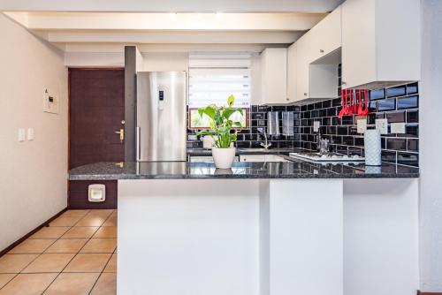 a kitchen with a large island in a room at CLASSIC A&W in Sandton