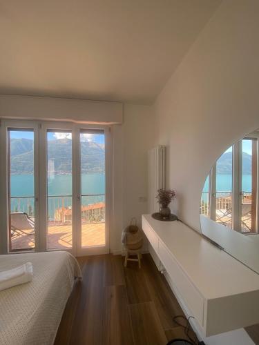 a bedroom with a bed and a view of the ocean at ORO, 8 in Bellano