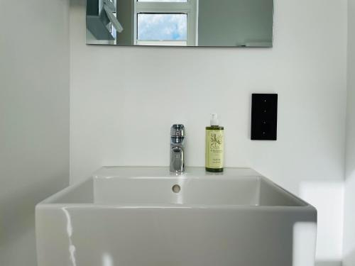 a white sink in a bathroom with a mirror at Designhotel Central Fulda in Fulda