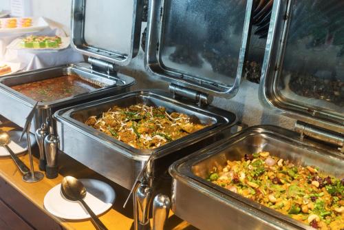 two trays of food sitting on a table at Manas Lifestyle Resort, Igatpuri in Igatpuri