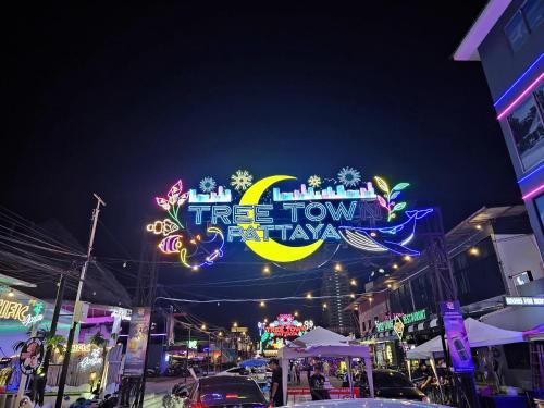a lit up sign for a town festival at night at The Base Inn Pattaya in Pattaya Central