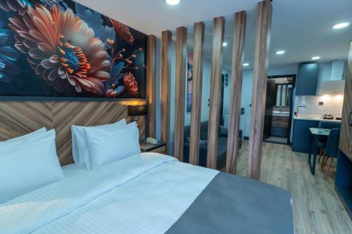 a bedroom with a bed with a painting on the wall at Yusufhan Suites in Trabzon