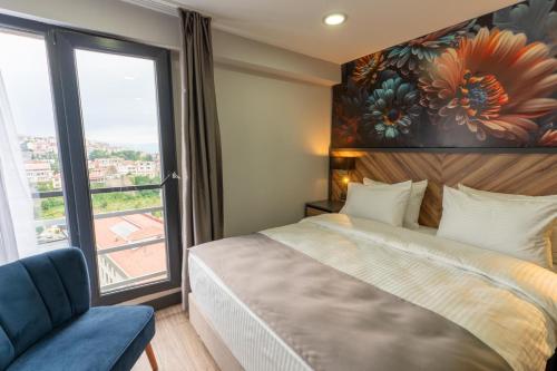 a bedroom with a bed and a large window at Yusufhan Suites in Trabzon