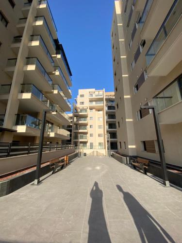 a shadow of a person standing between two buildings at Diamond House in Eilat