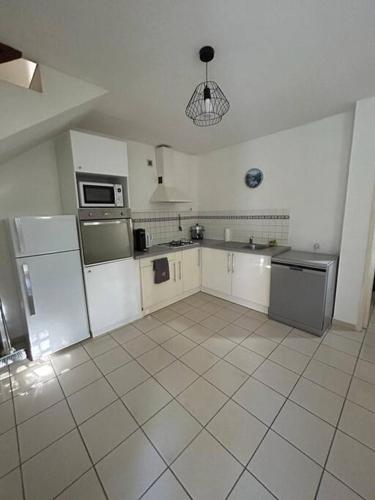 Eldhús eða eldhúskrókur á Maison à l'Ermitage