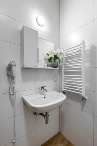 a white bathroom with a sink and a mirror at Hotel A4 Wrocław - Bielany in Bielany Wrocławskie