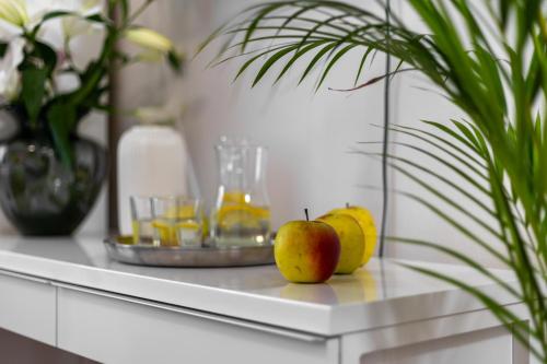 a table with fruit and drinks and a plant on it at Hotel A4 Wrocław - Bielany in Bielany Wrocławskie