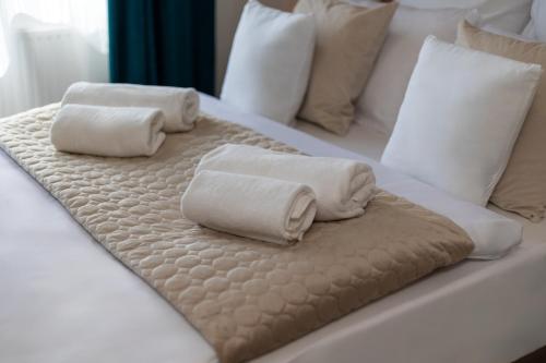 two towels on a bed with pillows on it at Hotel A4 Wrocław - Bielany in Bielany Wrocławskie