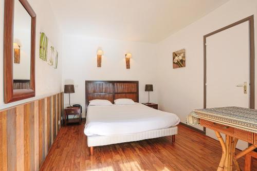 a bedroom with a bed and a mirror and a piano at Hôtel François d'O in Caen