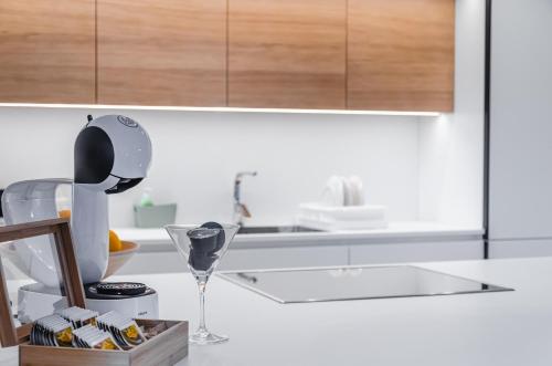 a kitchen with a counter top with a wine glass at Apartma Vila Center LUX in Slovenj Gradec