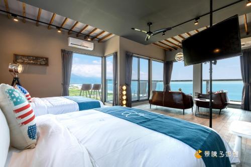 ein Hotelzimmer mit 2 Betten und einem Flachbild-TV in der Unterkunft 發現七星潭海景民宿 in Hualien