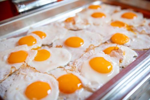 a pan filled with eggs on top of a pizza at Dunas Luxury Beach Resort Tarifa in Tarifa