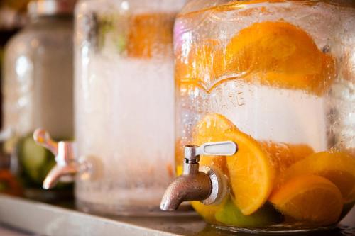 a glass jar filled with oranges and lime at Dunas Luxury Beach Resort Tarifa in Tarifa