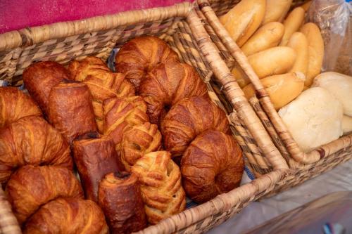 a basket full of bread and croissants and rolls at Dunas Luxury Beach Resort Tarifa in Tarifa