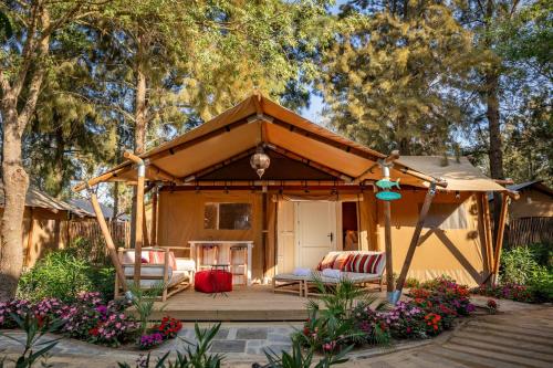 a gazebo with a couch and chairs in a yard at Dunas Luxury Beach Resort Tarifa in Tarifa