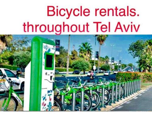 a group of bikes parked next to a fence at Sunny Garden. YBG. 1 Bedroom Apt. Quiet in Tel Aviv